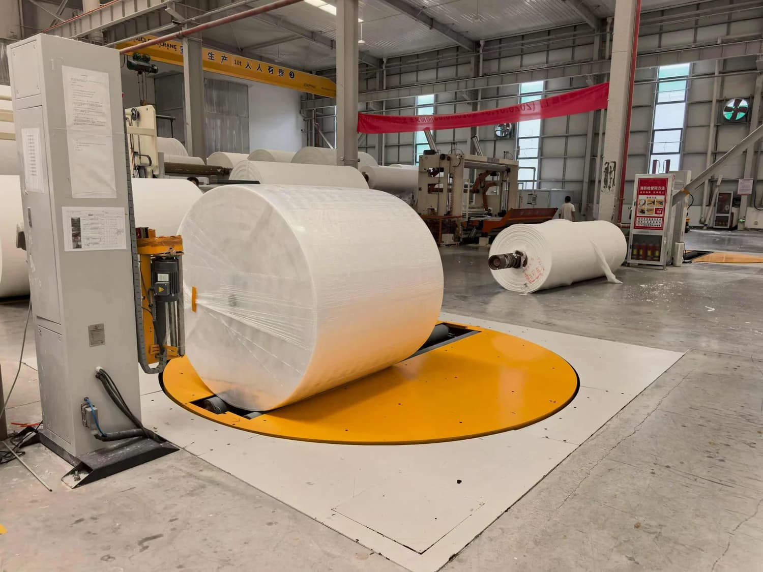 Jumbo reel wrapping in a paper mill